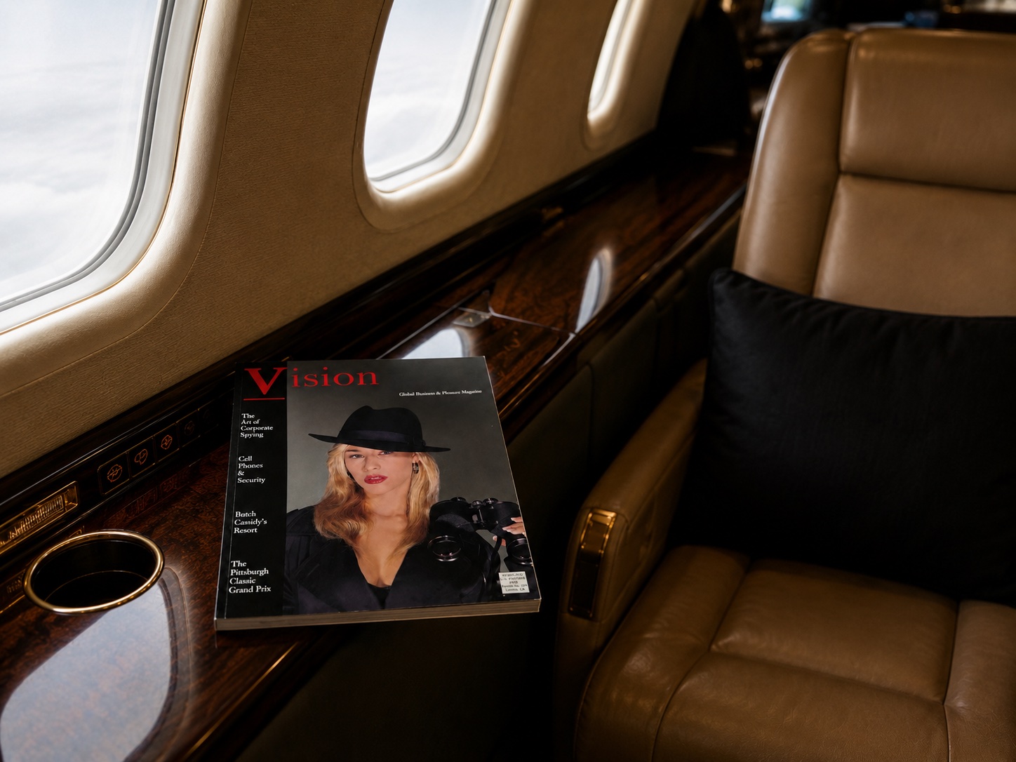 Vision Magazine resting on a private jet windowsill