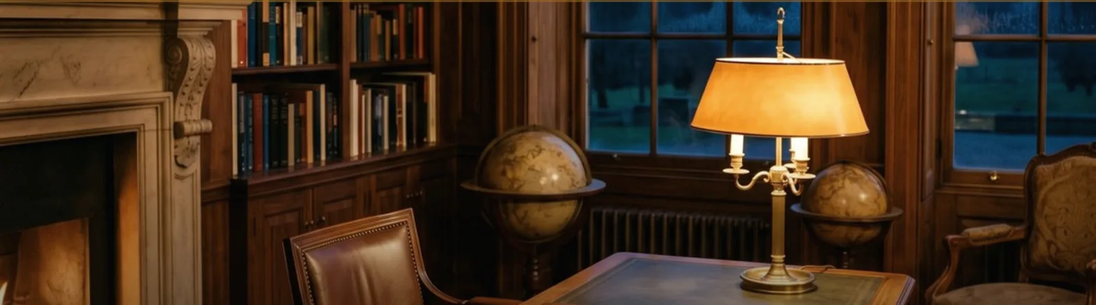 A private study at dusk, with a fireplace, bookshelves, globes and a lit brass desk lamp